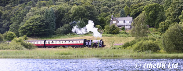 Steam train running next to Lake Windermere